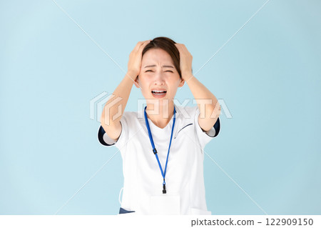 Woman, white coat, nurse, medical, holding head Woman, white coat, nurse, medical, holding head 122909150