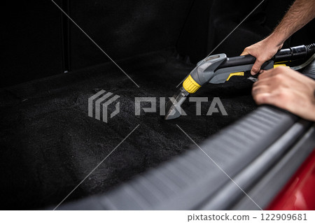 Professional vacuuming ensures dustfree trunk 122909681