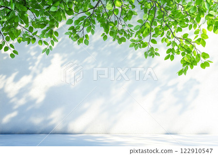 A scene where the shadow of a leaf is reflected on the wall A scene where the shadow of a leaf is reflected on the wall 122910547