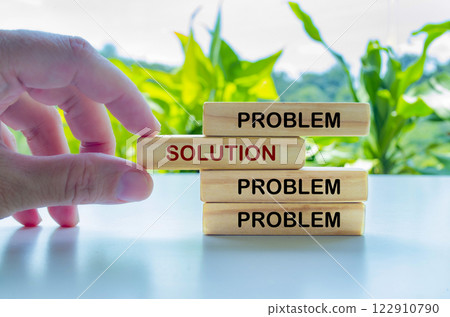 Hand putting Solution text on wooden blocks with other blocks with Problems Hand putting Solution text on wooden blocks with other blocks with Problems 122910790