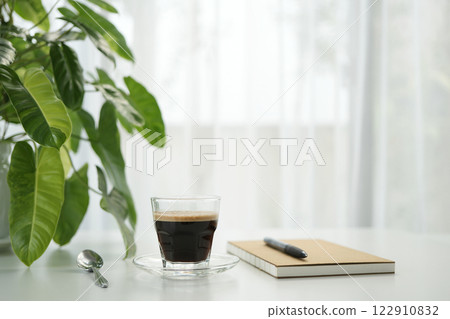 coffee cup and notebook by the window, minimal home 122910832