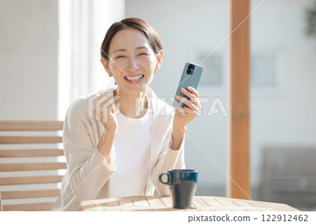 Woman operating a smartphone Woman operating a smartphone 122912462