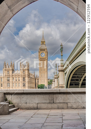 This shot captures an innovative photography angle for tourists in London, using the tunnel arch to frame Big Ben for a striking visual effect. This shot captures an innovative photography angle for tourists in London, using the tunnel arch to frame Big Ben for a striking visual effect. 122912594