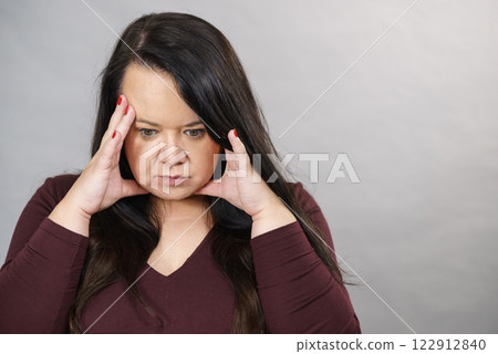 Worried woman having painfull headache 122912840