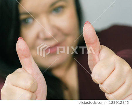 Woman making thumb up gesture Woman making thumb up gesture 122912845