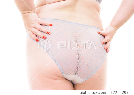 Plus size woman in lingerie back view. 122912951