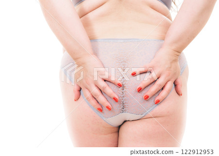 Plus size woman in lingerie back view. 122912953