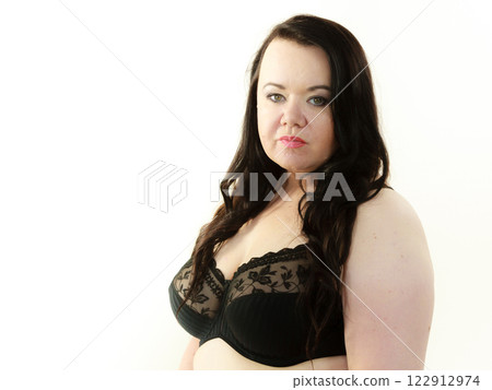 Woman in black bra showing her breast chest. Woman in black bra showing her breast chest. 122912974