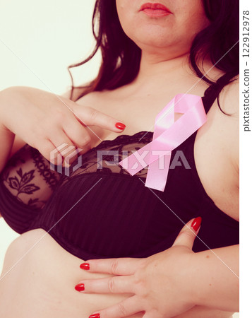 Woman chest in bra, pink cancer ribbon 122912978