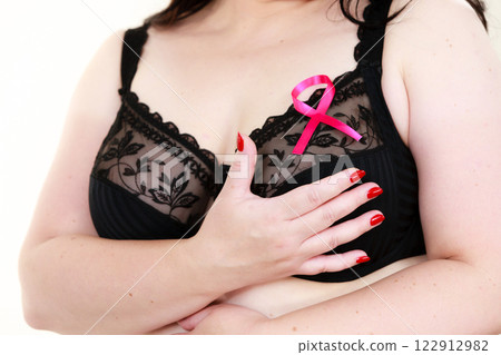 Woman chest in bra, pink cancer ribbon 122912982