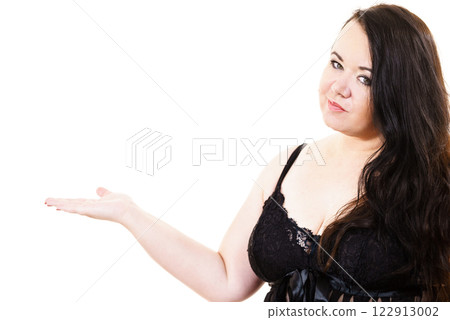 Woman plus size in lingerie holds open hand Woman plus size in lingerie holds open hand 122913002