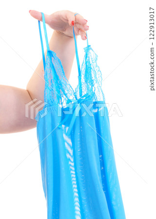 Woman holds blue babydoll 122913017