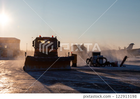 Snowplow truck cleans airport in the morning at winter 122913198