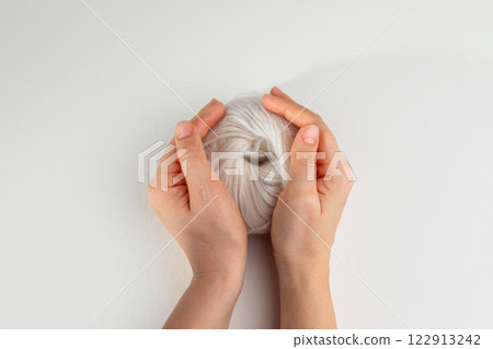 Ball of pink yarn on light background Ball of pink yarn on light background 122913242