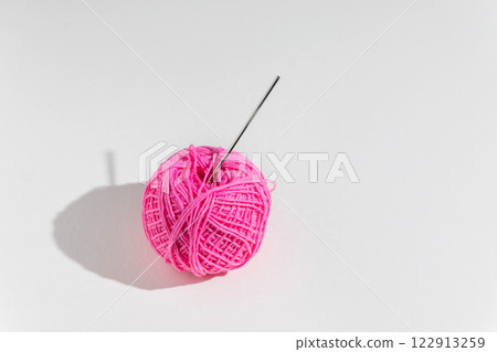 Ball of pink yarn on light background Ball of pink yarn on light background 122913259