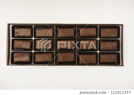 Chocolates in a box. A set of candies with white filling. Chocolates in a box. A set of candies with white filling. 122913357