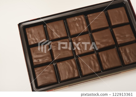 Chocolates in a box. A set of candies with white filling. 122913361