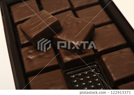 Chocolates in a box. A set of candies with white filling. Chocolates in a box. A set of candies with white filling. 122913371