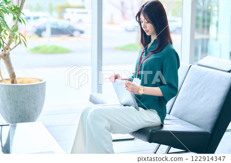 A businesswoman in casual clothes checking documents at a cafe. Photo courtesy of Sky Perfect Tokyo Media Center. A businesswoman in casual clothes checking documents at a cafe. Photo courtesy of Sky Perfect Tokyo Media Center. 122914347