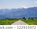 Snow-covered Mount Jonen and fresh greenery on Ohisama Road 122915072