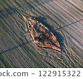 An aerial view shows a significant hole in a field 122915322