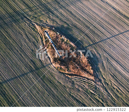 An aerial view shows a significant hole in a field 122915322
