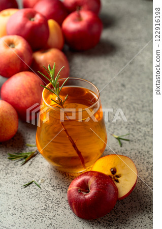Apple juice and fresh apples on a kitchen table. 122916198