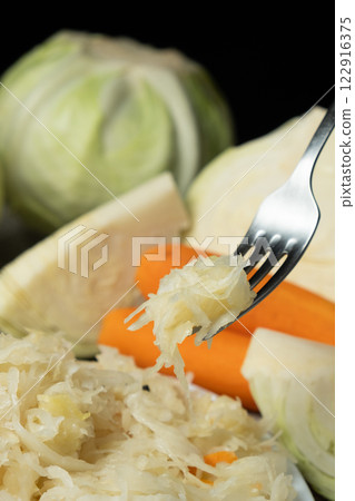 Sauerkraut salad traditional recipe consisting of cabbage, carrots, salt and peppercorns. 122916375