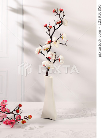 Abstract spring flower arrangement with cherry blossom branches in vase,elegant beauty concept,stage for product display and business concept.Minimal modern aesthetics 122916850