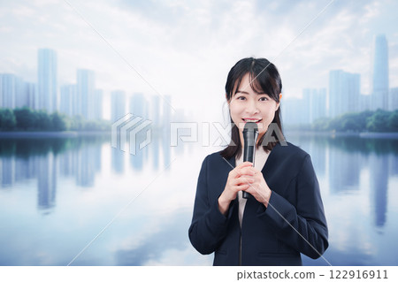 A young woman giving a speech using a microphone on a street corner A young woman giving a speech using a microphone on a street corner 122916911