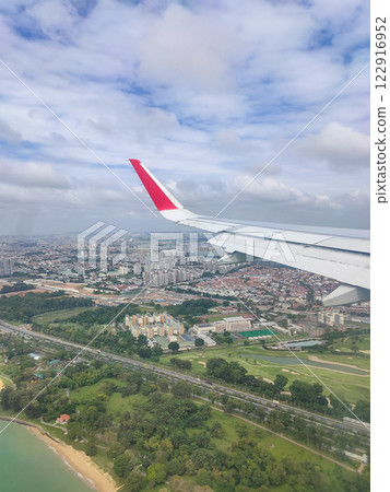 View of Singapore from a landing airplane out the window at day View of Singapore from a landing airplane out the window at day 122916952