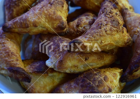 Golden-Brown Triangular Pastries Freshly Baked Golden-Brown Triangular Pastries Freshly Baked 122916961
