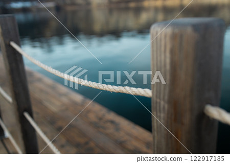 A detailed macro shot of a dock rope, showcasing the intricate fibers and textures of the tightly woven strands, perfect for nautical and marine themes. 122917185