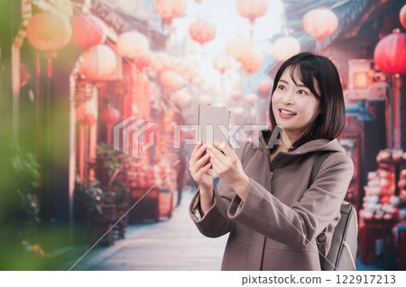 A young woman walking alone in a foreign city 122917213
