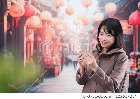 A young woman walking alone in a foreign city A young woman walking alone in a foreign city 122917214