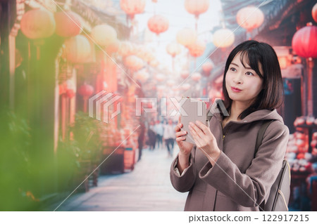 A young woman walking alone in a foreign city 122917215