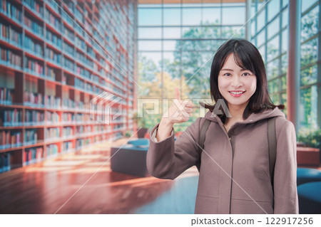 Smiling young woman on college campus 122917256