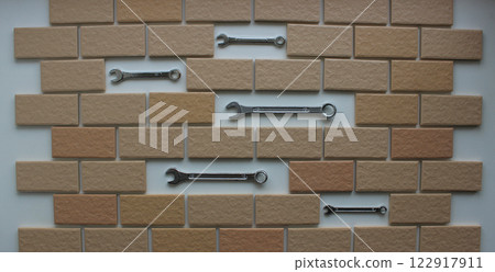 Steel Wrenches In Compartments Inside Tiles Brickwork Top View. Stock Photo For DIY Repair Illustration  122917911
