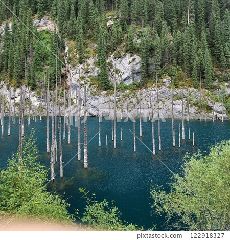 Beautiful view of the lake. Rocky mountains covered with coniferous trees. Beautiful view of the lake. Rocky mountains covered with coniferous trees. 122918327