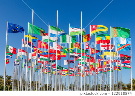 Many world's countries national flags waving on the wind, with European Union, Zambian, Sierra Lione, Uzbek, Turkmen, Togo, Ethiopian banners in the foreground, Doha, Qatar 122918874