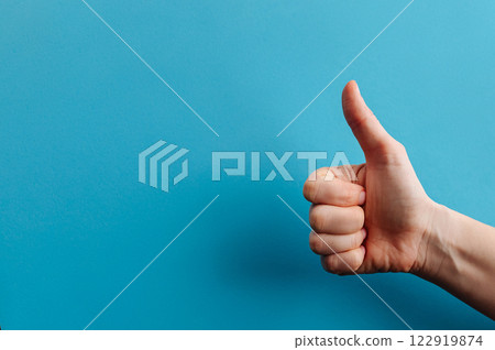 thumbs up hand sign. woman hand showing thumb up, like, okay, approval, acceptance, positive hand gesture 122919874