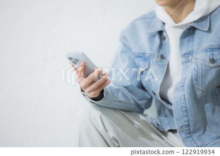 A man operating a smartphone A man operating a smartphone 122919934
