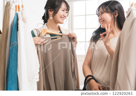 A woman shopping for clothes at an apparel shop A woman shopping for clothes at an apparel shop 122920261