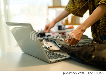 Close up of designer measuring denim pants preparing for a new design concept Close up of designer measuring denim pants preparing for a new design concept 122920458
