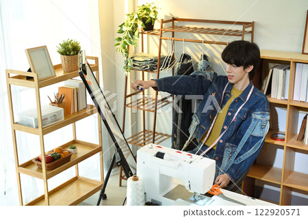 Fashion designer sketching or presenting ideas on a whiteboard 122920571