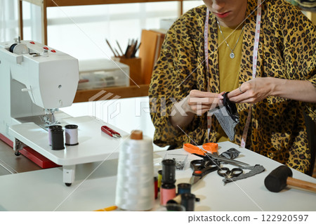 Cropped shot of stylish designer working on fabric sample in a fashion studio Cropped shot of stylish designer working on fabric sample in a fashion studio 122920597