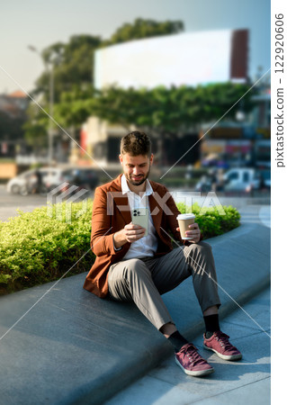 Young businessman using a smartphone outdoors in a modern urban Young businessman using a smartphone outdoors in a modern urban 122920606