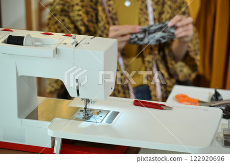 Close up of a modern sewing machine in a designer workspace 122920696