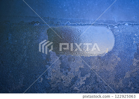 Close-Up of Frozen Water Droplets on a Cold Glass Surface 122925063