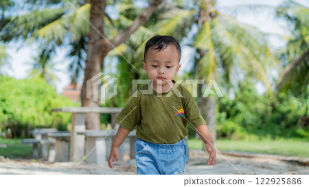 Cute Asian Boy Exploring Tropical Beach Paradise Under Palm Trees Sunshine 122925886
